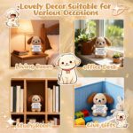 A grey crochet dog miniature figure with floppy ears and blush details, holding a sign with an encouraging message.