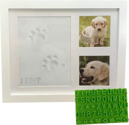 White wooden picture frame with a clay paw print impression and two photo slots, with a stencil kit beside it.