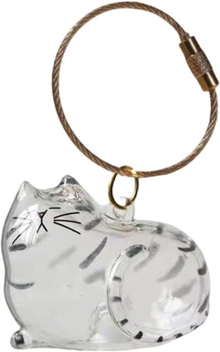 Transparent cat-shaped keychain with a small amount of pet fur visible inside, attached to a split ring.