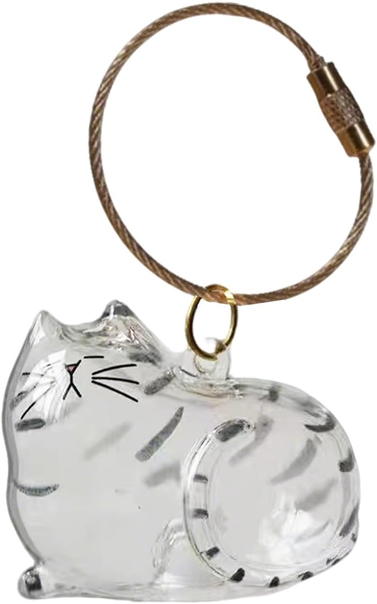 Transparent cat-shaped keychain with a small amount of pet fur visible inside, attached to a split ring.