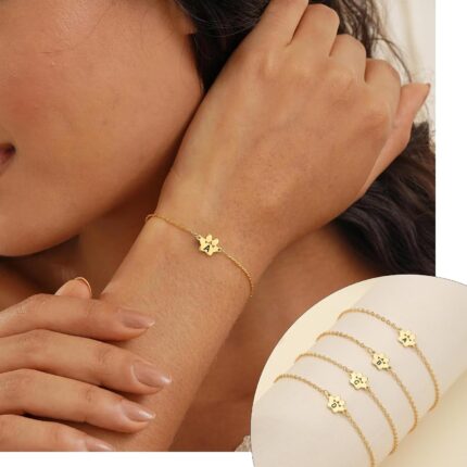 Close-up of a gold-plated DONYUDE dog paw initial charm bracelet on a white background, suitable for women.