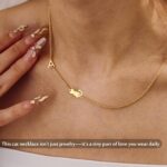 Close-up of a DONYUDE gold-plated necklace featuring a dainty cat's head pendant with the initial 'S' on a polished chain.