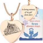 Close-up of a rose gold heart-shaped pendant necklace with a custom pet photo and engraved text, on a snake chain.