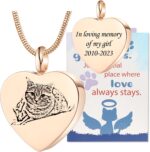Close-up of a rose gold heart-shaped pendant necklace with a custom pet photo and engraved text, on a snake chain.
