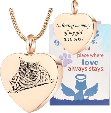 Close-up of a rose gold heart-shaped pendant necklace with a custom pet photo and engraved text, on a snake chain.
