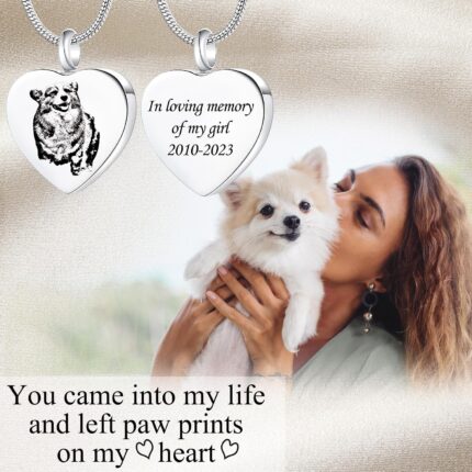Close-up of a rose gold heart-shaped pendant necklace with a custom pet photo and engraved text, on a snake chain.