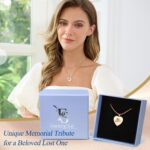 Close-up of a rose gold heart-shaped pendant necklace with a custom pet photo and engraved text, on a snake chain.