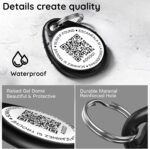 Close-up of a round, black ILFINDYOU QR code pet ID tag with an eagle design, attached to a dog collar.