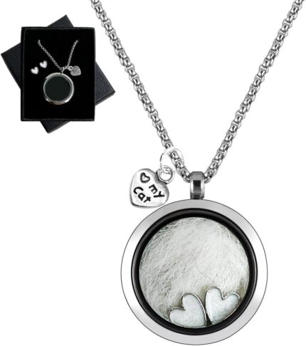 Silvery circular glass and metal necklace with a cat charm, designed to hold pet ashes or fur as a memorial.
