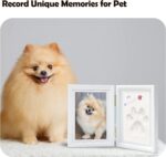 A white rectangular wooden frame with a pet's paw print impression in clay, a photo slot, and decorative trinkets.