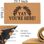 A colorful rectangular doormat with the humorous text "Yay You're Here!" in bold letters, set against a bright background.