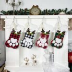 A single grey pet paw shaped Christmas stocking from Sexybody, hanging, with a white cuff and a loop for hanging.