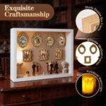White XINGZUAN Museum of Us DIY Shadow Box Kit on a tabletop, displaying mini gold frames, figurines, and an LED light.