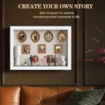 White XINGZUAN Museum of Us DIY Shadow Box Kit on a tabletop, displaying mini gold frames, figurines, and an LED light.
